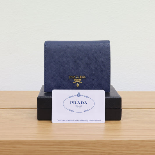 Pre-owned authentic PRADA 2018 Saffiano Leather Navy Bi-fold Clasp Slim Wallet 1M0204 | Box + G Card | Luxe Again Maison
