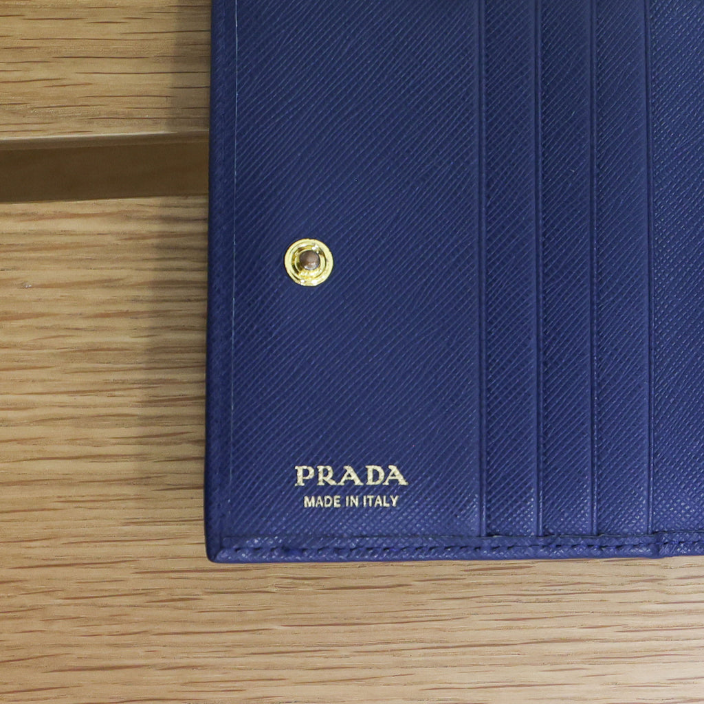 Pre-owned authentic PRADA 2018 Saffiano Leather Navy Bi-fold Clasp Slim Wallet 1M0204 | Box + G Card | Luxe Again Maison