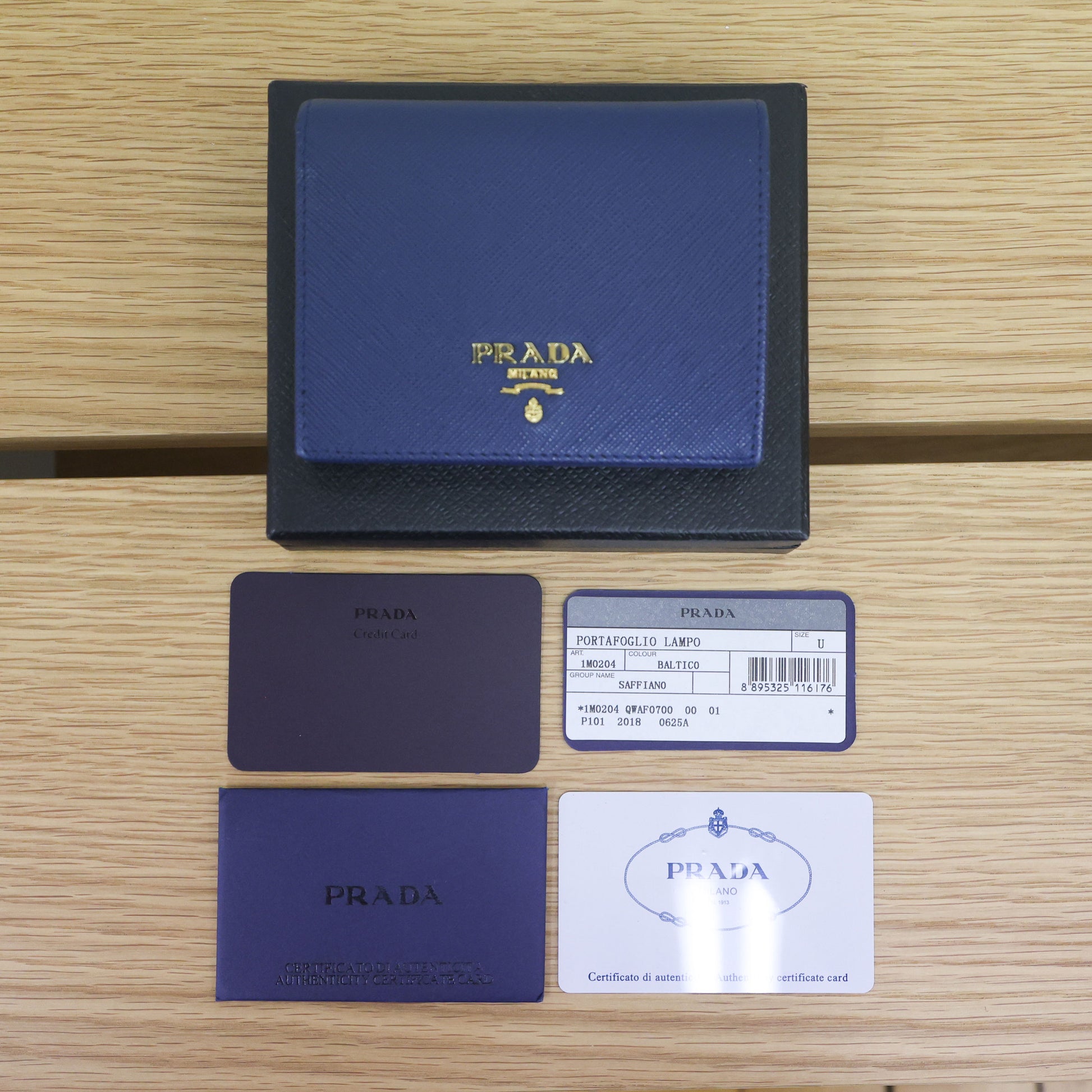 Pre-owned authentic PRADA 2018 Saffiano Leather Navy Bi-fold Clasp Slim Wallet 1M0204 | Box + G Card | Luxe Again Maison
