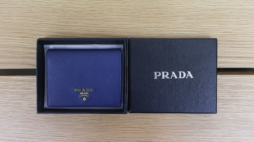 Pre-owned authentic PRADA 2018 Saffiano Leather Navy Bi-fold Clasp Slim Wallet 1M0204 | Box + G Card | Luxe Again Maison