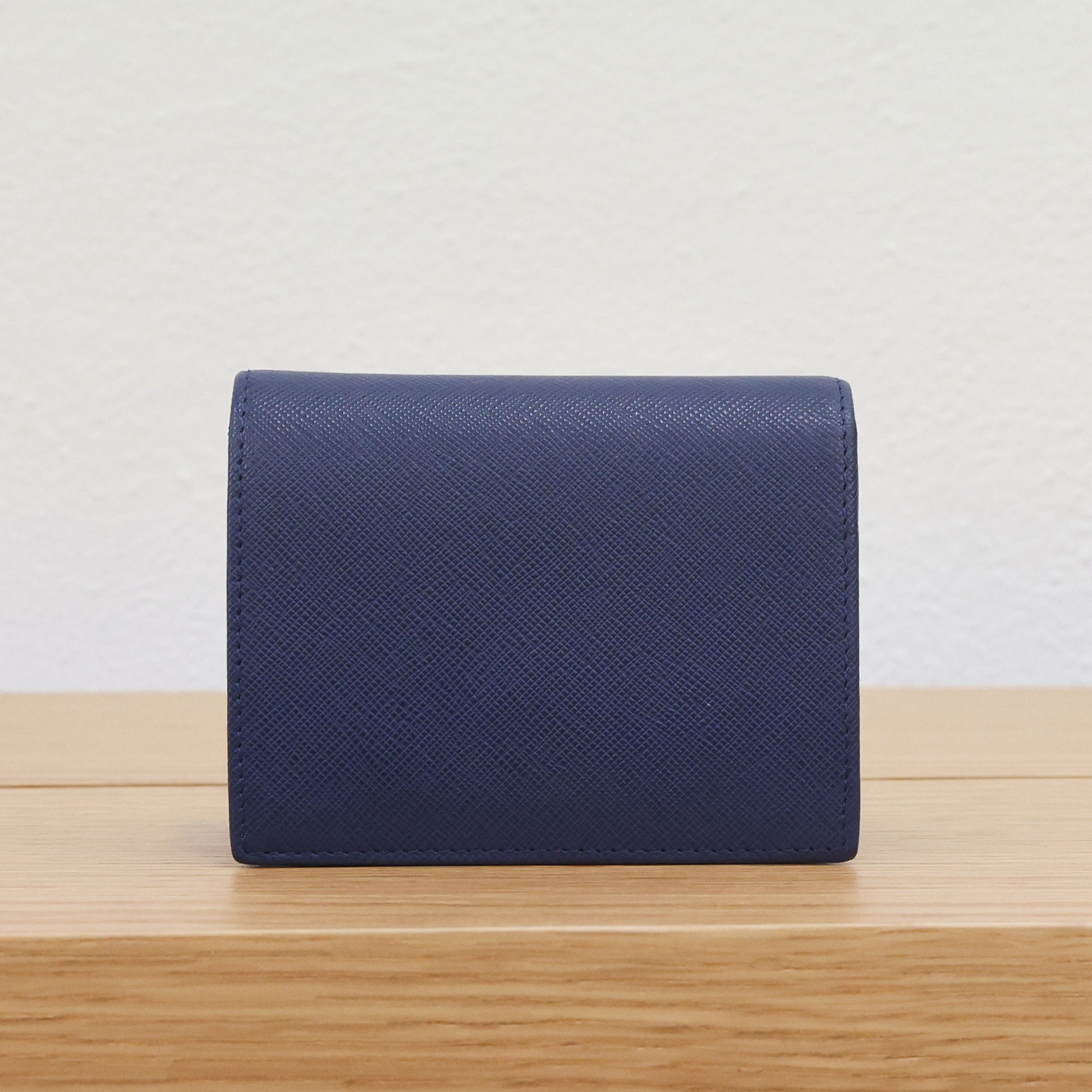 Pre-owned authentic PRADA 2018 Saffiano Leather Navy Bi-fold Clasp Slim Wallet 1M0204 | Box + G Card | Luxe Again Maison