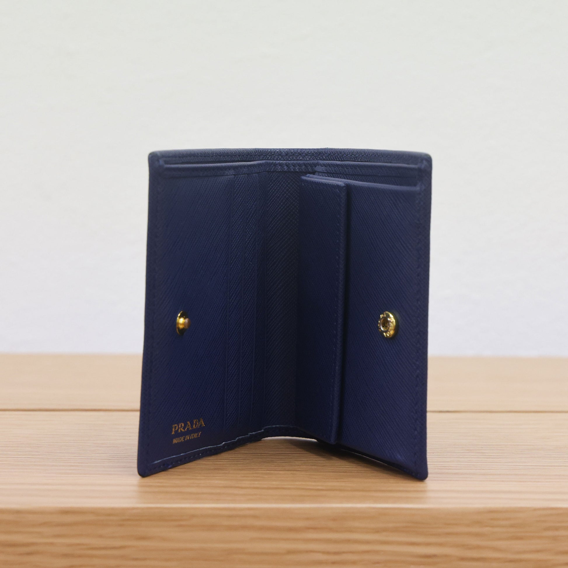 Pre-owned authentic PRADA 2018 Saffiano Leather Navy Bi-fold Clasp Slim Wallet 1M0204 | Box + G Card | Luxe Again Maison