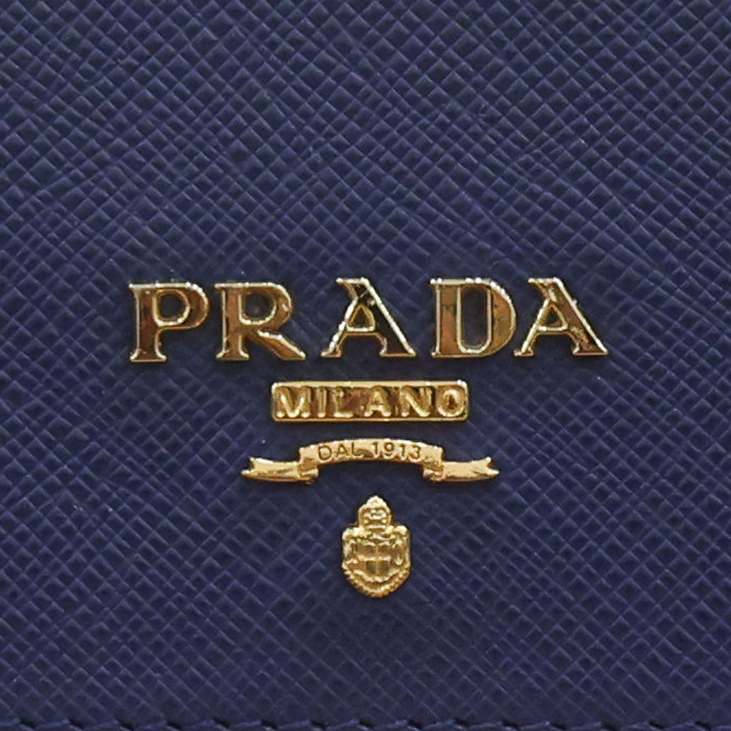 Pre-owned authentic PRADA 2018 Saffiano Leather Navy Bi-fold Clasp Slim Wallet 1M0204 | Box + G Card | Luxe Again Maison