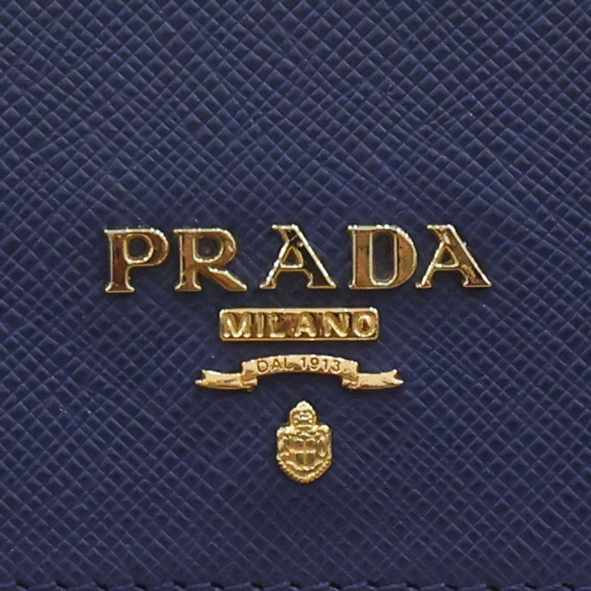 Pre-owned authentic PRADA 2018 Saffiano Leather Navy Bi-fold Clasp Slim Wallet 1M0204 | Box + G Card | Luxe Again Maison